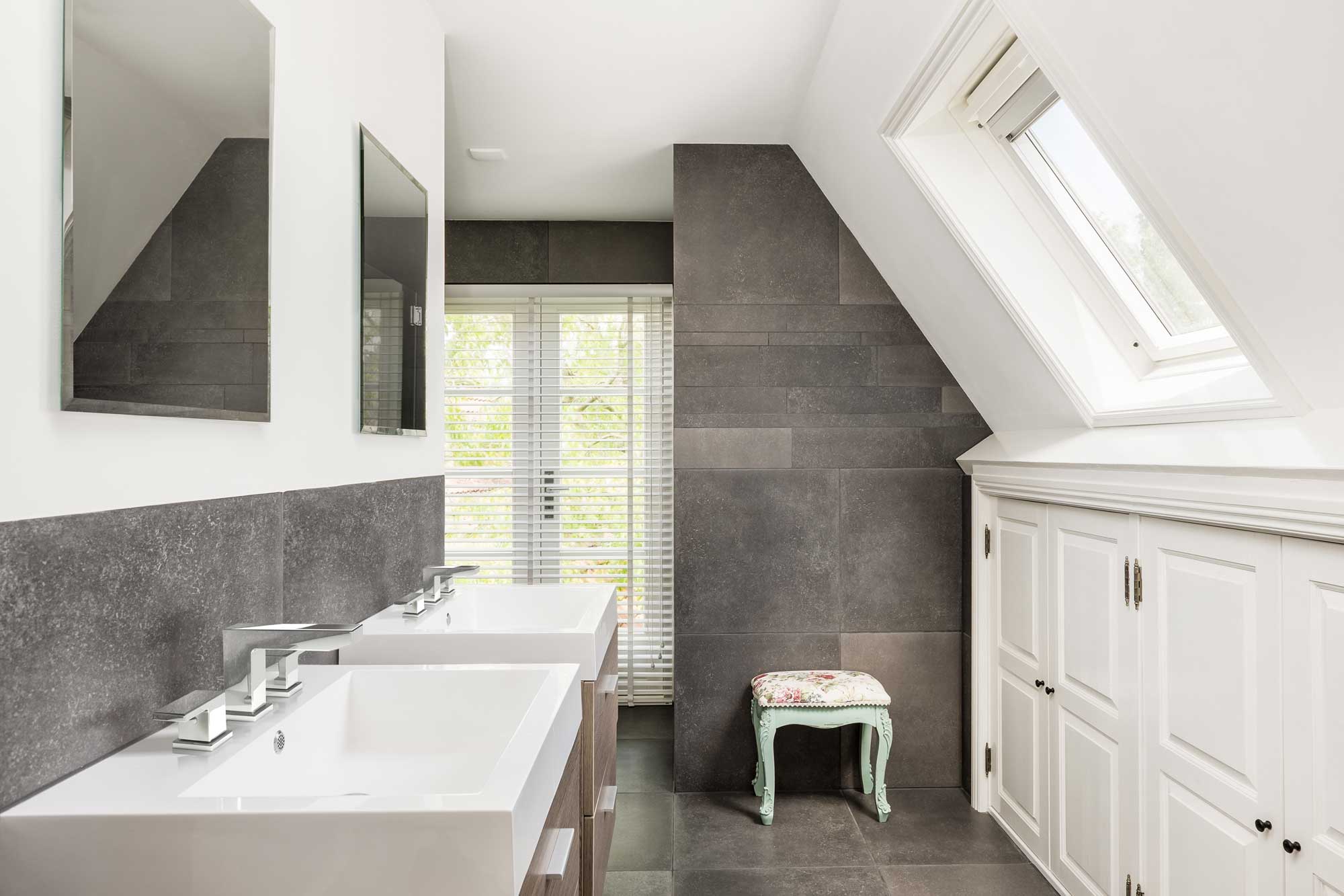 A bathroom featuring a sink and a mirror above it, with neutral-colored walls and a clean, modern design.