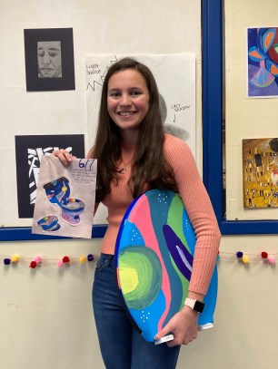 Alexis Alvarado stands with her initial design and toilet seat. (Photo credit: Caitlin Shawaker)