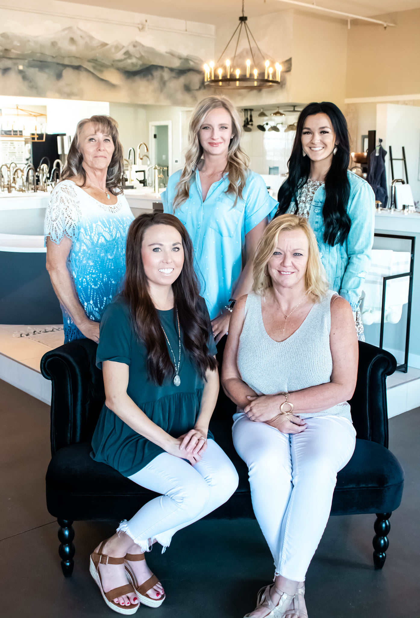 The team members stand together outside the lakeside shop, smiling and showcasing their friendly atmosphere.